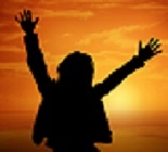 Person holding their arms up silluehted by the sun.